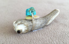 Load image into Gallery viewer, This mountain lion almost looks like the old style wolf except the tail is carved slimmer. This mountain lions eyes are inlaid with black pen shell. The offering bundle has a gold lip mother of pearl and a nugget kingman turquoies. 