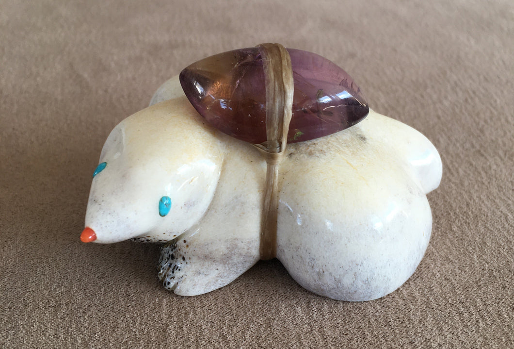 A shrew carved of Elk antler. The eyes are of sleeping beauty turquoise and a coral nose. A rose tourmaline is the offering in the bundle. 