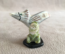 Load image into Gallery viewer, A road runner in its environment. Searching for food. He is carved of Elk antler inlaid with malachite eyes and has black jet, green serpentine and pipe stone pigment for detailing. The Cactus is carved of green serpentine. The legs of the road runner are copper round wire and the base is black marble. 