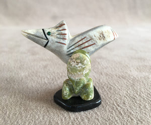 A road runner in its environment. Searching for food. He is carved of Elk antler inlaid with malachite eyes and has black jet, green serpentine and pipe stone pigment for detailing. The Cactus is carved of green serpentine. The legs of the road runner are copper round wire and the base is black marble. 