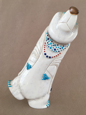 This turquoise clawed dancing Elk antler bear is also inlaid with turquoise eyes. The necklace is inlaid with turquoise, lapis and coral. The ceremonial robe has more turquoise, lapis, coral, malachite, abaloine, red/orange spiny shell, pink mussel, green serpentine and pen shell. The parrot and pottery design is inlaid with black jet pigment. He can dance of either foot. 